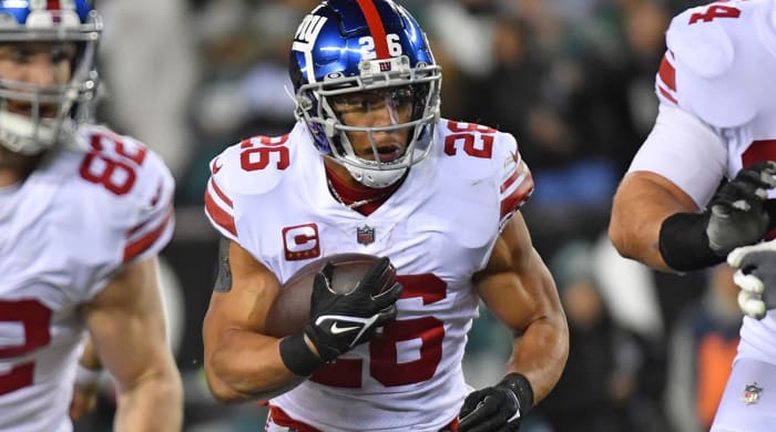 Saquon Barkley runs with the football